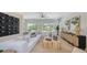Stylish living room with comfortable seating, modern decor, and ample natural light from large windows at 8800 Midnight Pass Rd, Sarasota, FL 34242