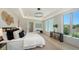 Serene main bedroom featuring modern design, a cozy seating area, and ample natural light at 8800 Midnight Pass Rd, Sarasota, FL 34242