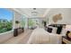 Bright main bedroom with balcony access features serene views and modern decor at 8800 Midnight Pass Rd, Sarasota, FL 34242