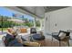 Elegant outdoor patio with comfortable seating, stylish decor, and a view of the beautifully landscaped backyard at 8800 Midnight Pass Rd, Sarasota, FL 34242