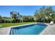 Sparkling pool and lush landscaping provide a serene and private backyard oasis at 8800 Midnight Pass Rd, Sarasota, FL 34242