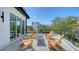 Outdoor rooftop deck with chairs and table with views of nearby tropical scenery at 8800 Midnight Pass Rd, Sarasota, FL 34242
