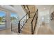 Contemporary staircase with metal railings and natural light, blending style and functionality at 8800 Midnight Pass Rd, Sarasota, FL 34242
