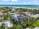 Coastal property with a white exterior, balconies, and lush landscaping, offering scenic ocean views at 89 Avenida Messina, Sarasota, FL 34242