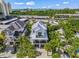 Stunning aerial view of a modern home with a metal roof, surrounded by lush greenery and ocean views at 89 Avenida Messina, Sarasota, FL 34242