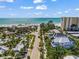Aerial view of beach house surrounded by palm trees with close beach access at 89 Avenida Messina, Sarasota, FL 34242