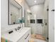 Modern bathroom featuring marble countertop, modern fixtures, and walk-in shower with glass surround at 89 Avenida Messina, Sarasota, FL 34242