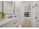 Elegant bathroom with marble countertop, modern fixtures, and walk-in shower with subway tile surround at 89 Avenida Messina, Sarasota, FL 34242