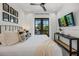Comfortable bedroom featuring a king bed, a balcony, and coastal-inspired decor at 89 Avenida Messina, Sarasota, FL 34242