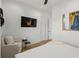 Bright bedroom featuring light wood floors, modern lighting and a seating area at 89 Avenida Messina, Sarasota, FL 34242