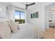 Bright bedroom with a king bed, ceiling fan, a private balcony, and serene views at 89 Avenida Messina, Sarasota, FL 34242
