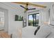 Bedroom with wood beam ceiling, spiral staircase access, natural light and ceiling fan at 89 Avenida Messina, Sarasota, FL 34242