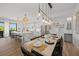 Dining area with modern decor, shiplap wall detail, and elegant lighting fixtures at 89 Avenida Messina, Sarasota, FL 34242