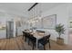 Dining area featuring an elegant table setting, modern lighting, and seamless flow into the kitchen at 89 Avenida Messina, Sarasota, FL 34242