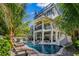 Luxurious home featuring a private pool, slide, and outdoor lounge areas at 89 Avenida Messina, Sarasota, FL 34242
