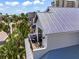 Modern coastal home with a metal roof, balcony, and ocean views at 89 Avenida Messina, Sarasota, FL 34242