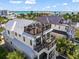 Stunning multi-story home showcasing multiple balconies and rooftop deck overlooking the ocean at 89 Avenida Messina, Sarasota, FL 34242