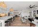 Open floorplan includes a kitchen island with stools, dining area, and living space with modern furnishings at 89 Avenida Messina, Sarasota, FL 34242