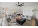 Open-concept living space featuring modern decor, a stylish ceiling fan, and seamless flow to the kitchen at 89 Avenida Messina, Sarasota, FL 34242