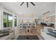 Bright open concept space with modern furnishings including the living room, dining room and kitchen at 89 Avenida Messina, Sarasota, FL 34242