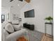 Modern living room featuring shiplap walls, stylish decor, comfortable seating, and hardwood floors at 89 Avenida Messina, Sarasota, FL 34242