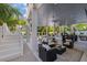 Spacious outdoor living area featuring an outdoor kitchen, bar area, comfortable seating, and in-ground spa at 89 Avenida Messina, Sarasota, FL 34242