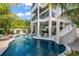 Stunning backyard pool with slide and lush tropical landscaping creating a private oasis at 89 Avenida Messina, Sarasota, FL 34242