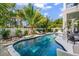 Backyard pool featuring a sun shelf and lush landscaping at 89 Avenida Messina, Sarasota, FL 34242