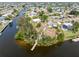 Aerial shot of a waterfront property featuring a private dock and mature trees at 891 Palmetto Ne Dr, Port Charlotte, FL 33952