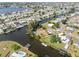 Aerial view of waterfront community with canals providing boating access to many homes at 891 Palmetto Ne Dr, Port Charlotte, FL 33952