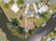 Overhead view of a property with a canal, boat dock, and surrounding residential neighborhood at 891 Palmetto Ne Dr, Port Charlotte, FL 33952