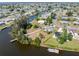 High-angle view of the waterfront property showcasing lush landscaping, private dock, and serene canal access at 891 Palmetto Ne Dr, Port Charlotte, FL 33952
