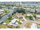 Overhead image of a waterfront home with a dock, landscaping, and neighborhood canals at 891 Palmetto Ne Dr, Port Charlotte, FL 33952