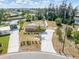 Aerial view of the charming single-story brick home featuring a well-maintained lawn and canal access at 891 Palmetto Ne Dr, Port Charlotte, FL 33952