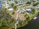 Aerial shot featuring a single-story waterfront property with a well-maintained yard at 891 Palmetto Ne Dr, Port Charlotte, FL 33952