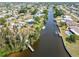 Aerial view of waterfront community with houses situated on a network of canals at 891 Palmetto Ne Dr, Port Charlotte, FL 33952
