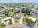 Stunning aerial view showcasing a waterfront property with lush landscaping, private dock, and serene canal access at 891 Palmetto Ne Dr, Port Charlotte, FL 33952