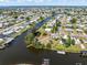 Wide aerial view of a waterfront community with canals and single-Gathering homes at 891 Palmetto Ne Dr, Port Charlotte, FL 33952
