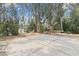 An expansive concrete patio features outdoor seating and a grill, ideal for entertaining by the water at 891 Palmetto Ne Dr, Port Charlotte, FL 33952