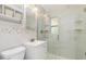 Well-lit bathroom featuring a modern vanity, tiled shower with glass door, and decorative accents at 891 Palmetto Ne Dr, Port Charlotte, FL 33952