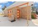 A brick exterior house boasts a cozy outdoor seating area, perfect for enjoying the Florida sunshine at 891 Palmetto Ne Dr, Port Charlotte, FL 33952