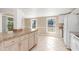 Well-lit kitchen featuring updated countertops and a refrigerator at 891 Palmetto Ne Dr, Port Charlotte, FL 33952