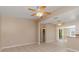Open concept living area with ceiling fans and ceramic tile flooring, offering comfort and easy maintenance at 891 Palmetto Ne Dr, Port Charlotte, FL 33952