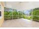 Screened patio with tile flooring, offering an outdoor living space at 891 Palmetto Ne Dr, Port Charlotte, FL 33952