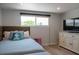 Bedroom featuring a comfortable bed, wood floors, a TV on the cabinet and a window for natural light at 91 Avenida Veneccia, Sarasota, FL 34242