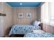 Cozy bedroom featuring nautical decor, twin beds, and a serene, beach-inspired ambiance with blue ceilings at 91 Avenida Veneccia, Sarasota, FL 34242