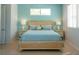Comfortable bedroom featuring a soft blue color scheme, a cushioned bed, and natural lighting at 91 Avenida Veneccia, Sarasota, FL 34242