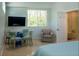 Inviting bedroom features a cozy sitting area, a flat screen TV, and an ensuite bathroom at 91 Avenida Veneccia, Sarasota, FL 34242