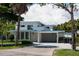 Charming two-story home with well-maintained landscaping, a carport, and a concrete driveway at 91 Avenida Veneccia, Sarasota, FL 34242