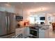 Modern kitchen with stainless steel appliances, granite countertops, and plenty of storage space at 91 Avenida Veneccia, Sarasota, FL 34242